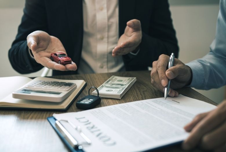 mesa com documentos sendo assinados para contrato de um seguro
