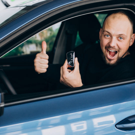 handsome-business-man-choosing-a-car-in-a-car-showroom